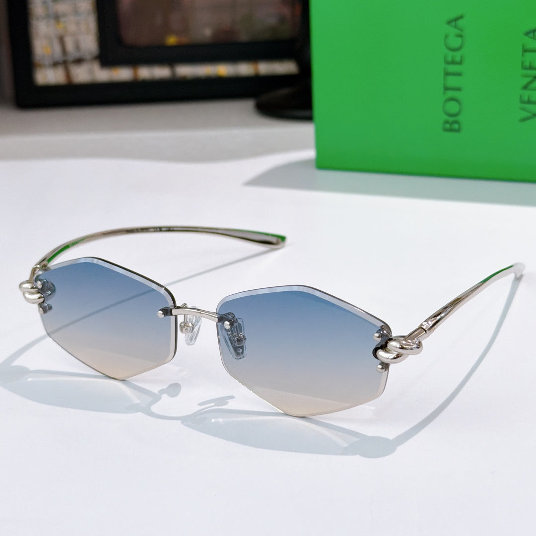 Gold metal sunglasses with blue-tinted lenses and green temple tips