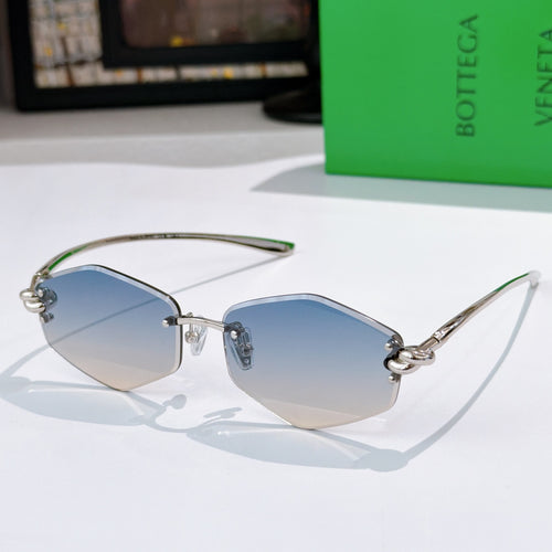 Gold metal sunglasses with blue-tinted lenses and green temple tips