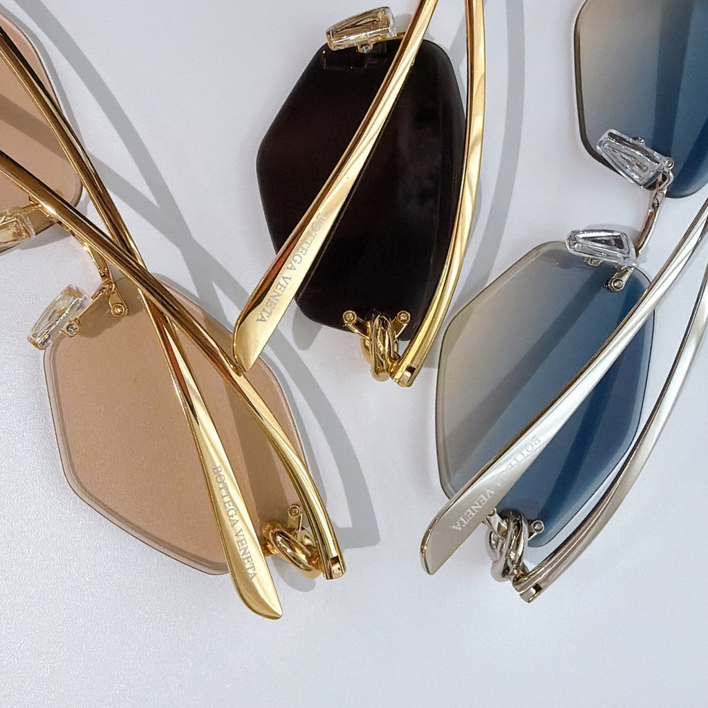 Set of gold and silver sunglasses with tinted lenses, shown side profile