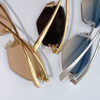 Set of gold and silver sunglasses with tinted lenses, shown side profile