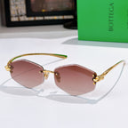 Gold metal sunglasses with rose-tinted lenses and hinged temple details