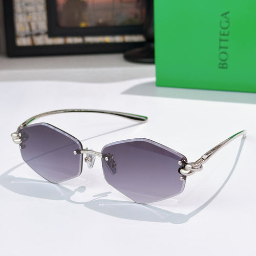 Gold metal sunglasses with dark purple lenses and green temple tips