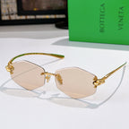 Gold metal sunglasses with light nude lenses and sculpted bridge