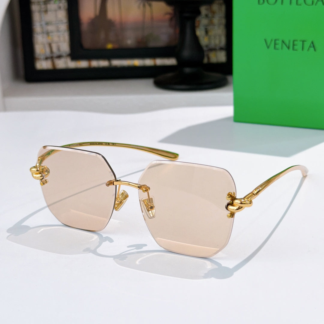 Bottega Veneta sunglasses, light tan lenses, gold-tone metal frame.
