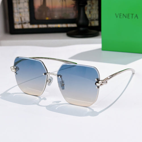 Bottega Veneta sunglasses, blue gradient lenses, gold-tone metal frame.