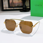 Bottega Veneta sunglasses, amber gradient lenses, gold-tone metal frame.