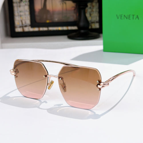 Bottega Veneta sunglasses, rose-brown gradient lenses, gold-tone metal frame.