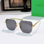 Bottega Veneta sunglasses, dark gray lenses, gold-tone metal frame.