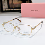 MiuMiu glasses with gold-tone frame and clear lenses, tortoise temple tips