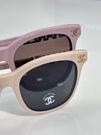 Chanel sunglasses close-up: light pink cat-eye frames with CHANEL emblem on the side.