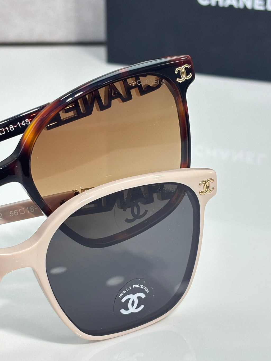 Chanel sunglasses close-up with tortoise and cream frames, gold CHANEL logo hinge detail