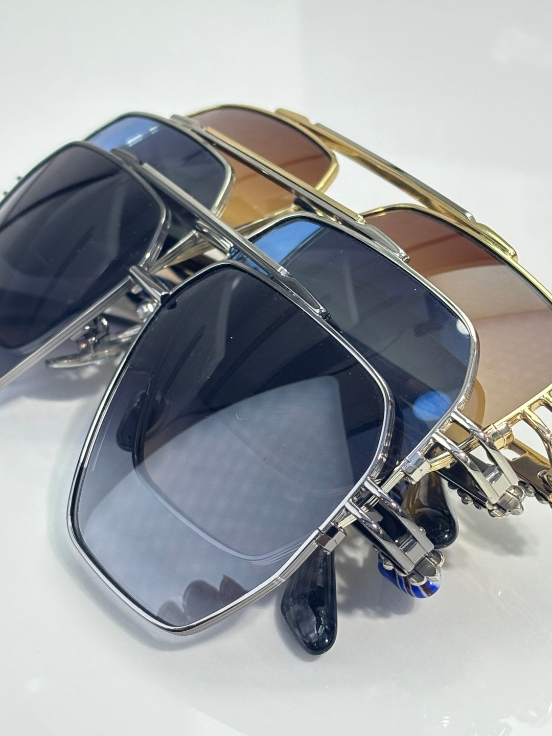 Sunglasses side view with gold-tone frame and dark lenses