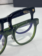 Navy blue glasses with green inner rims and gold decorative frame details
