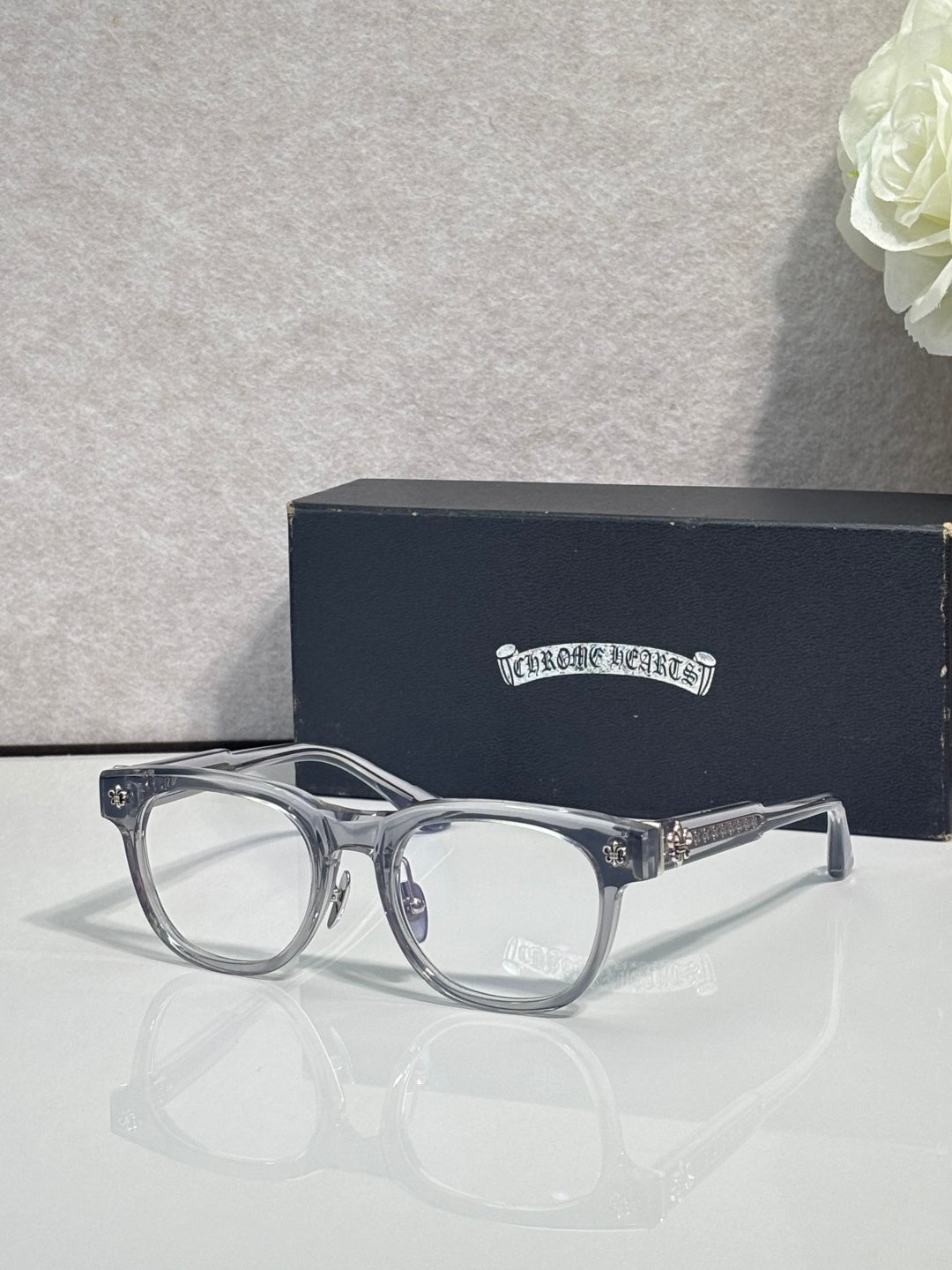 Clear eyeglasses with metal frame accents and ornate silver-tone temple details