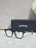 Black full-rim glasses with clear lenses and gold-tone decorative temple tips