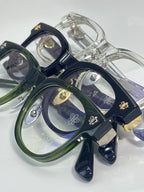 Set of full-rim glasses in navy, green, and clear tones with ornate gold accents