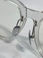 Clear glasses with rounded rectangular frames and metal bridge hardware