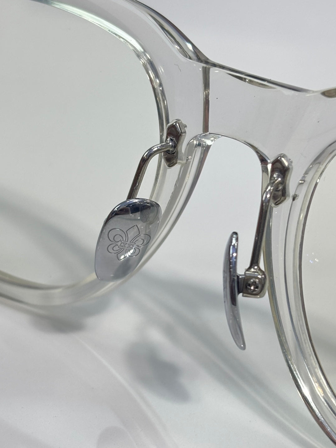 Clear glasses with rounded rectangular frames and metal bridge hardware