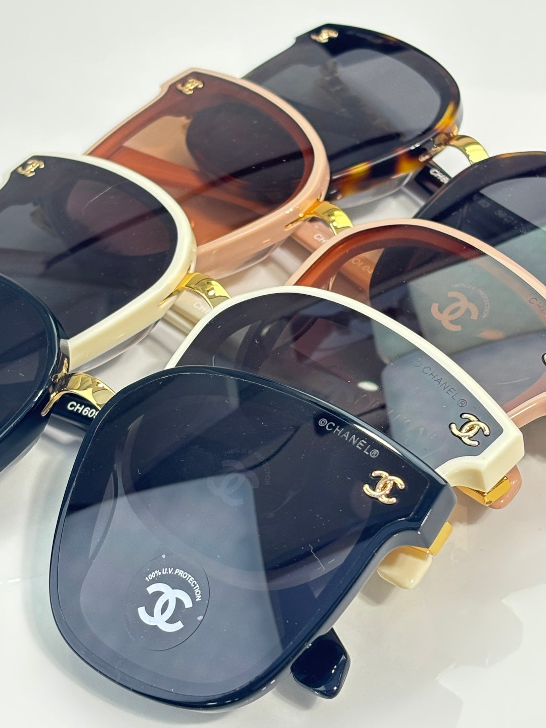 Chanel sunglasses set with mixed frames, dark lenses, and gold logo details