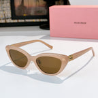 Beige cat-eye sunglasses with brown lenses and gold-tone temple logo accents