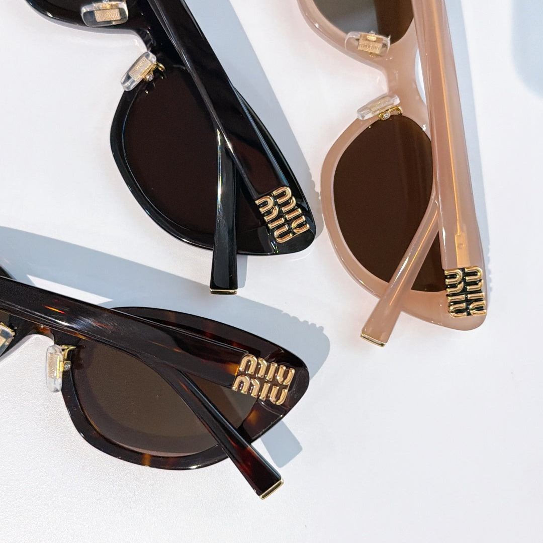 Two cat-eye sunglasses: black and blush-beige frames with dark lenses and gold logos