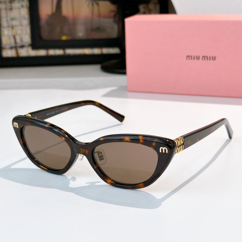 Tortoiseshell cat-eye sunglasses with brown lenses and gold-tone temple logo details