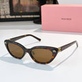 Dark tortoiseshell cat-eye sunglasses with brown lenses and gold-tone logo accents