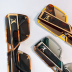 Assorted sunglasses with gold-tone frames and LV-style logo panels