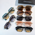 Assorted sunglasses with tinted lenses in teal, black, and pink tones.