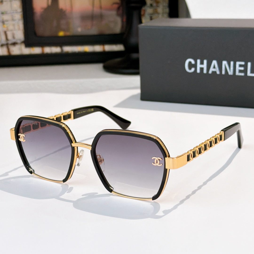 Gold and brown sunglasses with tinted lenses and chain-style temple detailing.