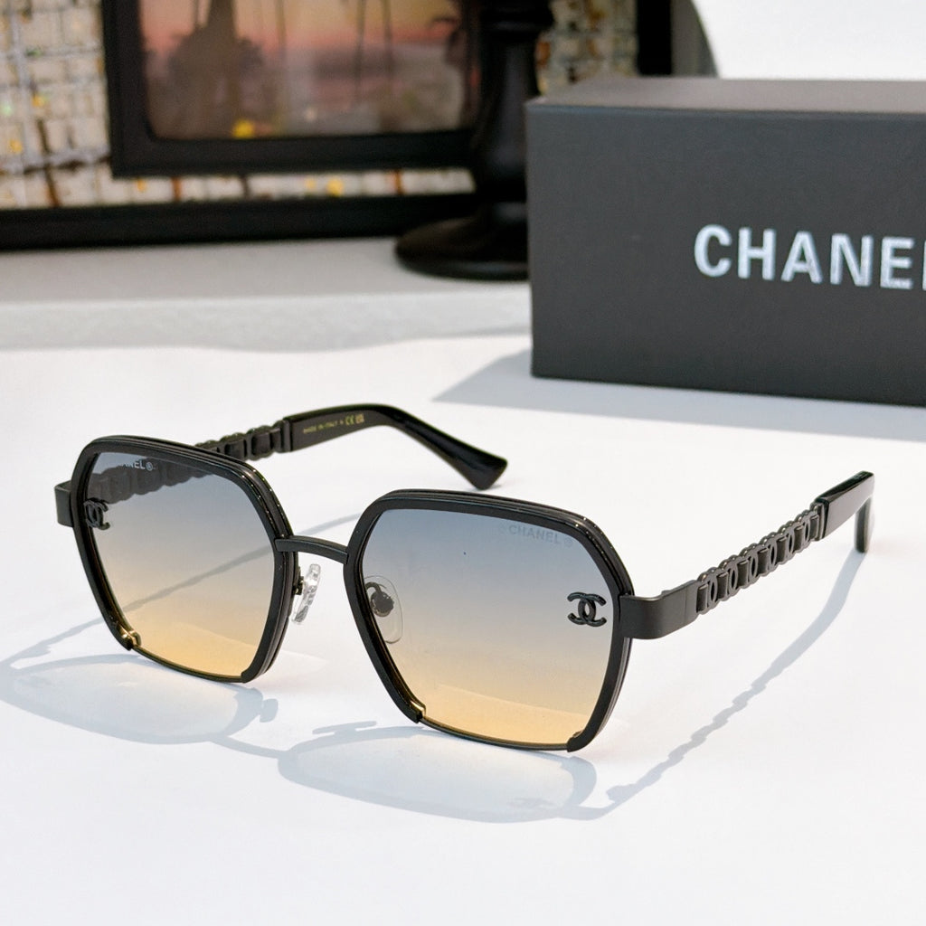 Black sunglasses with tinted lenses and chain-style temple detailing.