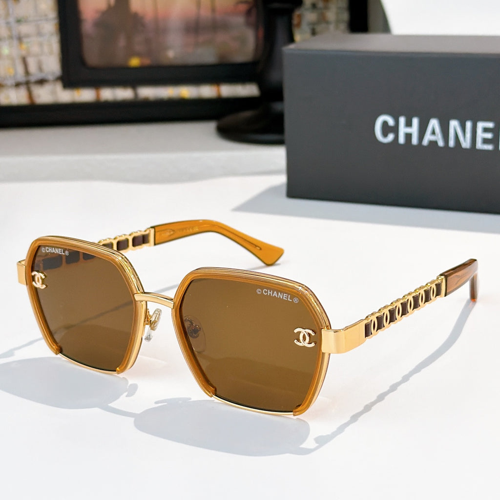 Gold and brown sunglasses with tinted lenses and chain-style temple detailing.