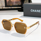 Gold and brown sunglasses with tinted lenses and chain-style temple detailing.