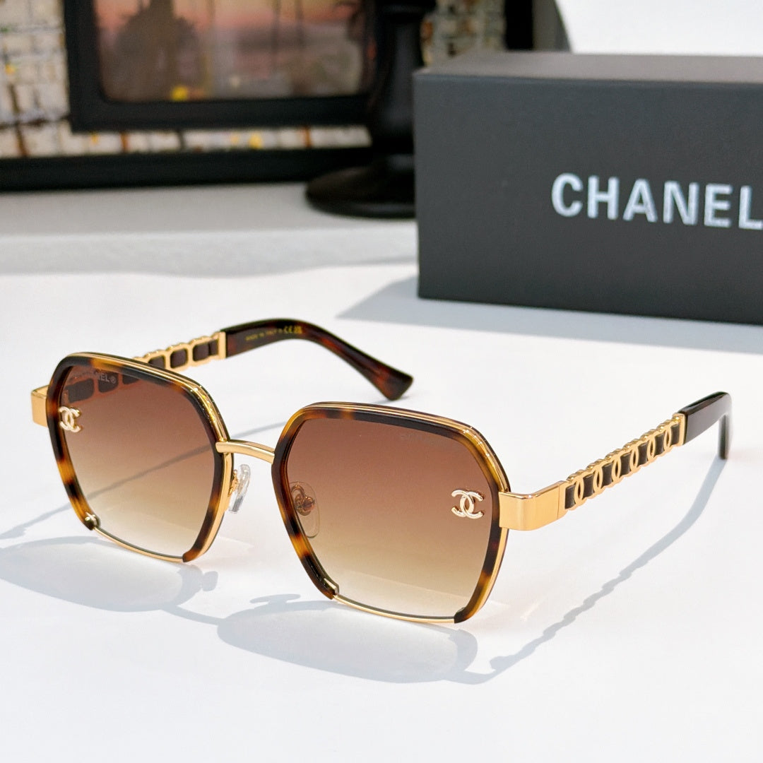 Gold and brown sunglasses with tinted lenses and chain-style temple detailing.