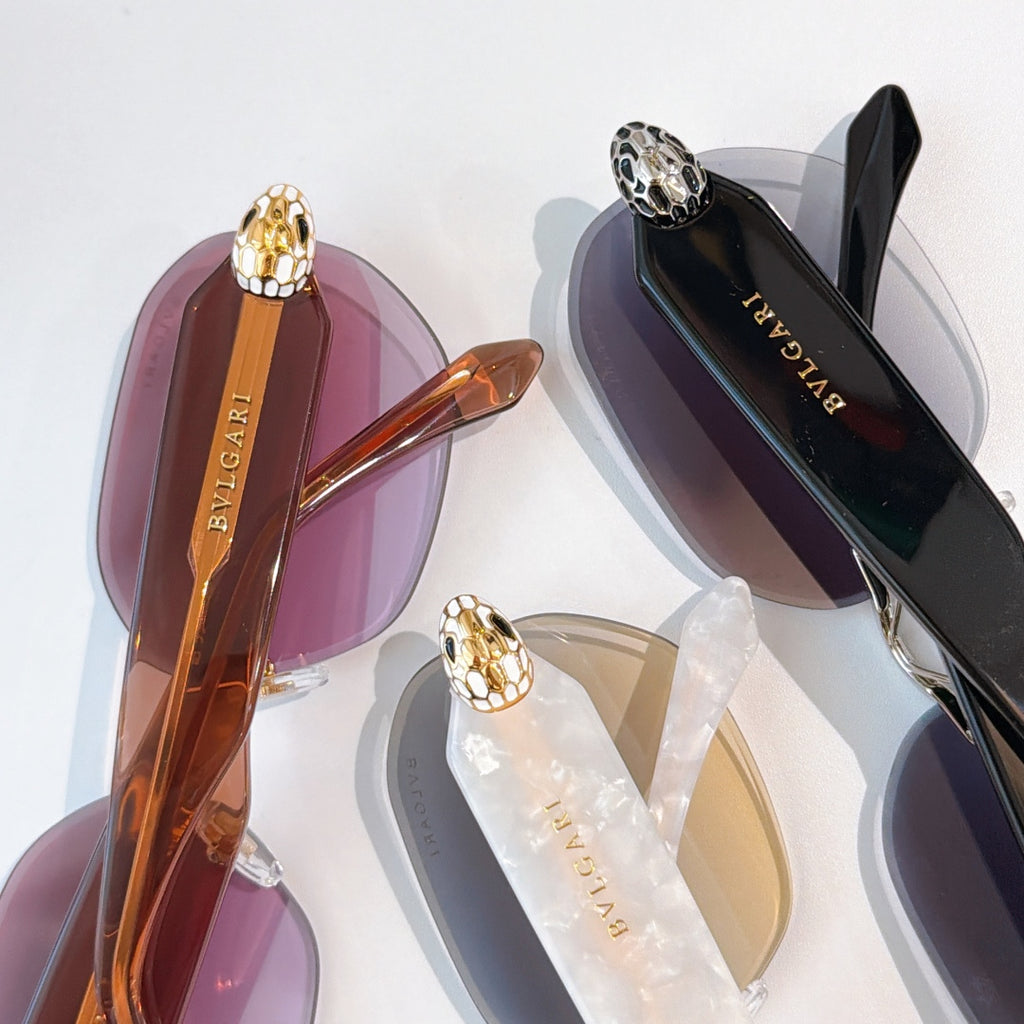 Bvlgari sunglasses close-up set with tinted lenses and gold temple emblems.