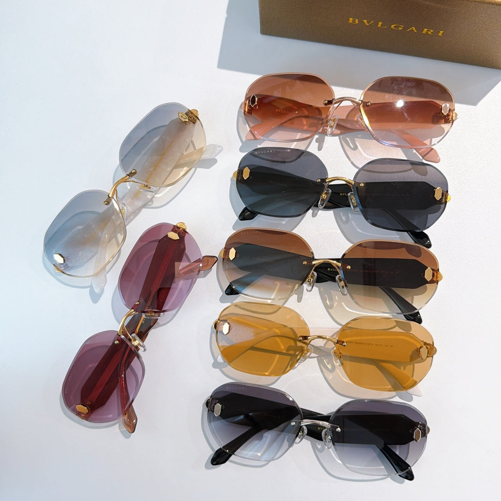 Assorted sunglasses with tinted lenses and gold-and-black frames.
