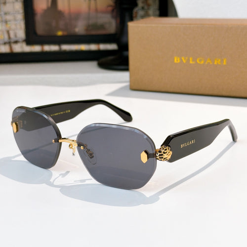Black sunglasses with dark lenses, gold logo accents, and sculpted temple hardware.
