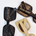 MiuMiu sunglasses set, black and tan frames with logo on temples