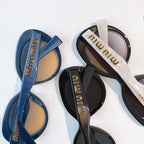 MiuMiu sunglasses set, blue and black frames with gold logo temples