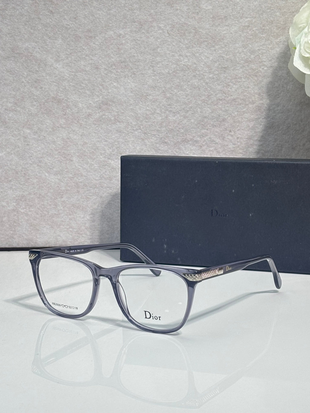 Dior eyeglasses with dark blue rectangular frames and clear lenses
