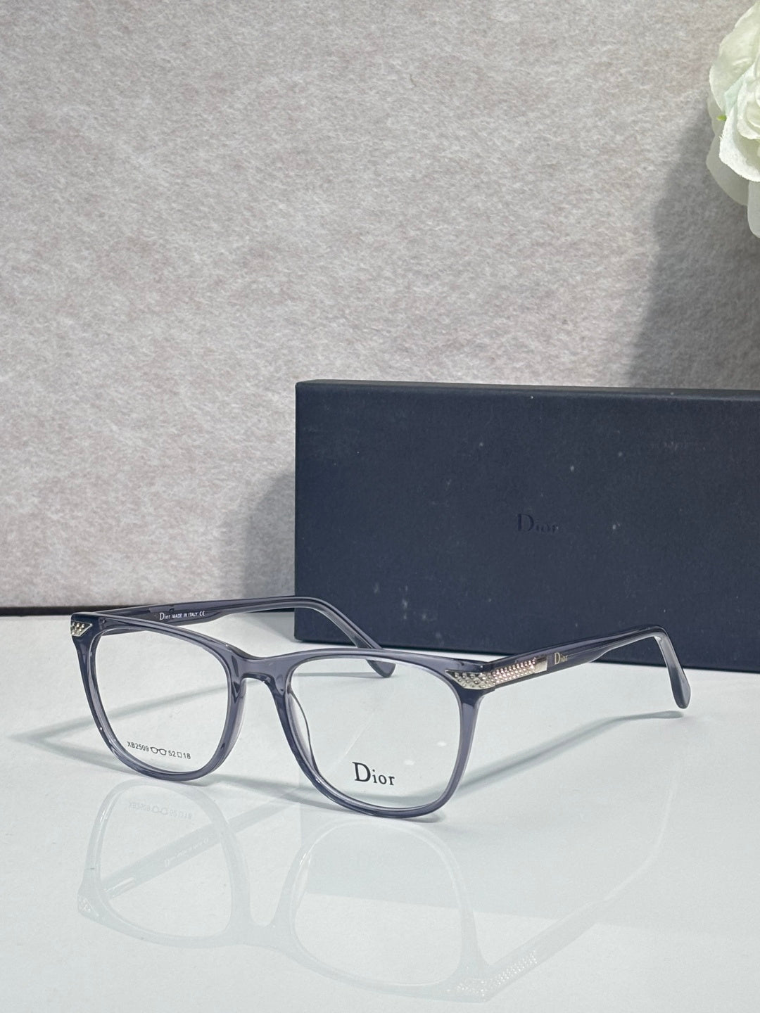 Dior eyeglasses with dark blue rectangular frames and clear lenses