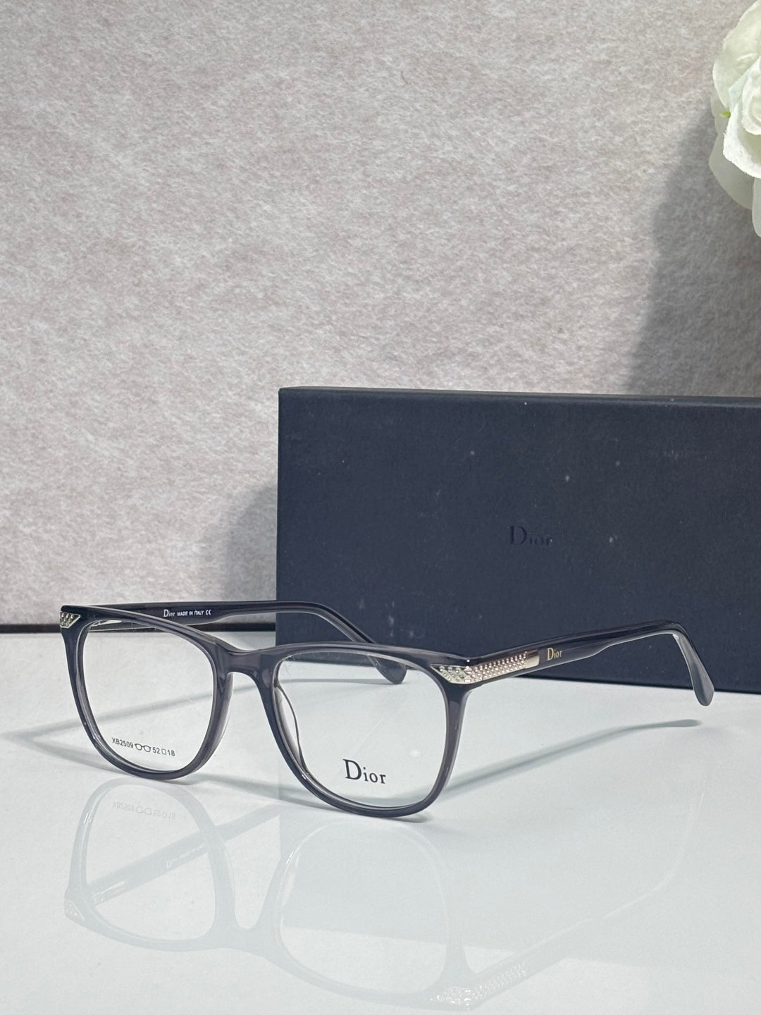 Dior eyeglasses with dark blue rectangular frames and gold-toned temple hardware
