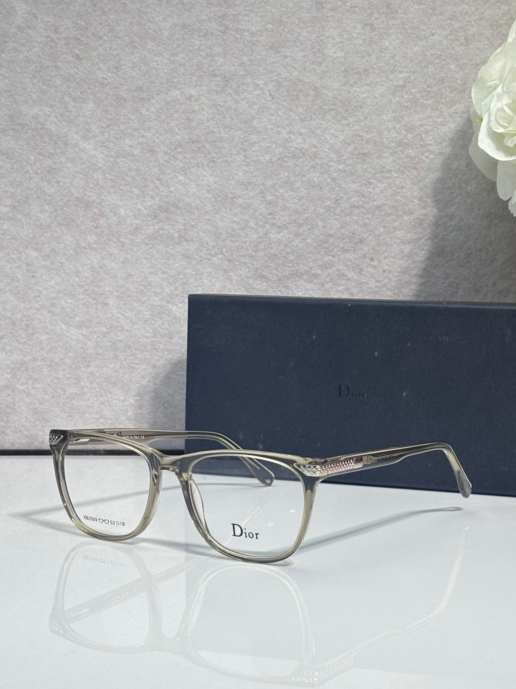 Dior eyeglasses with silver-toned frames and clear rectangular lenses