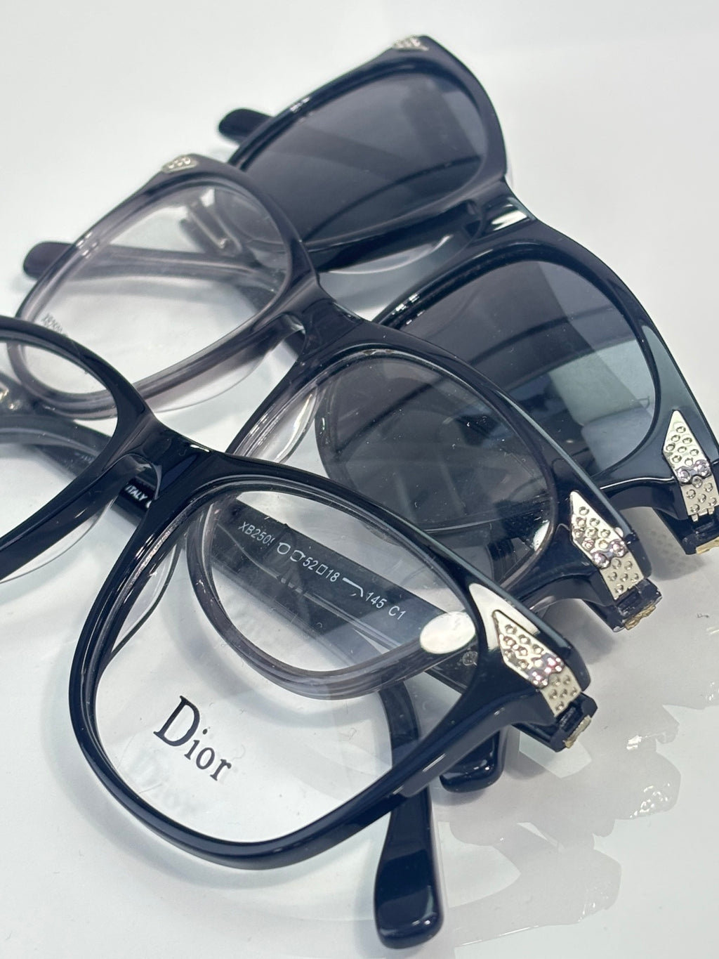 Dior sunglasses with dark blue frames and layered tinted lenses, top view