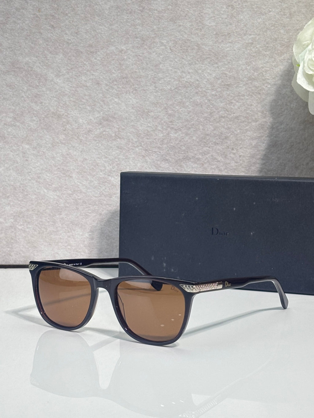 Dior sunglasses with dark frame and brown tinted lenses, three-quarter angle
