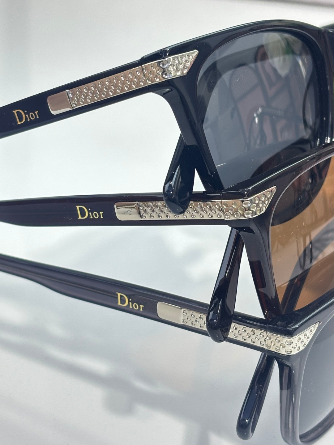 Dior sunglasses with rhinestone-studded temple arms and dark tinted lenses
