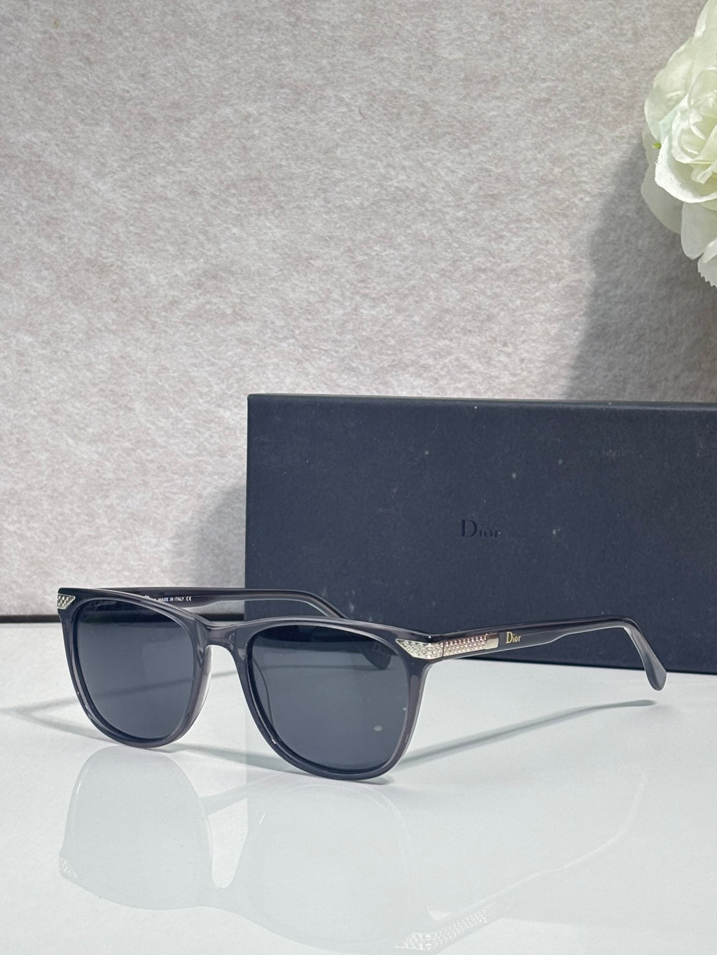 Dior sunglasses with dark frame and dark tinted lenses, front three-quarter view