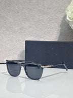 Dior sunglasses with dark frame and dark tinted lenses, front three-quarter view