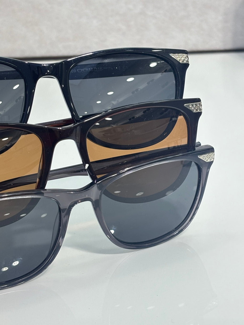 Set of Dior eyeglass frames in dark blue with tinted lenses, stacked close-up