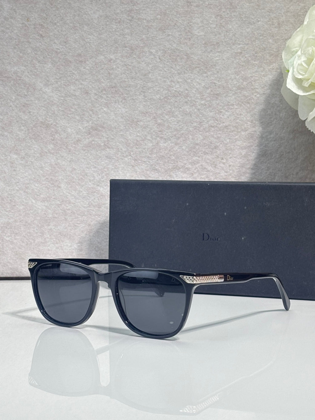 Dior dark blue sunglasses with glossy frame and dark tinted lenses